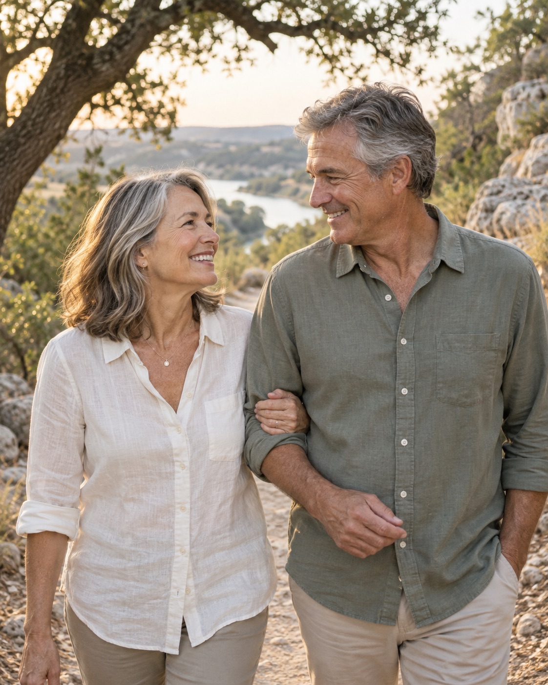 Illustrative couple approaching retirement enjoying a walk together among oak trees